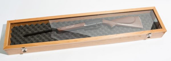 Shotgun in wooden display case.