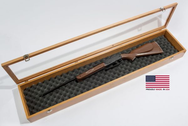 Shotgun in wooden case with American flag.