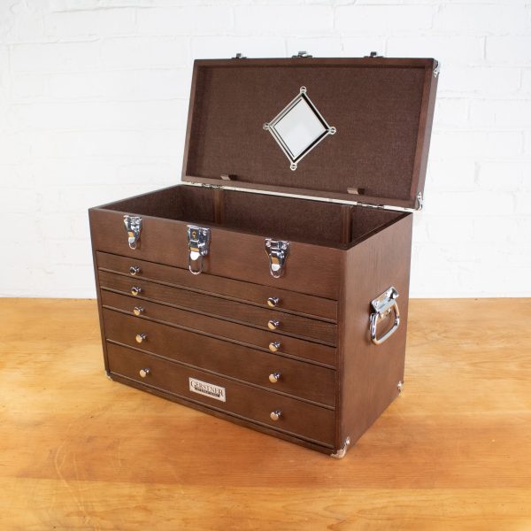 Open wooden Gerstner toolbox with drawers on wood floor.